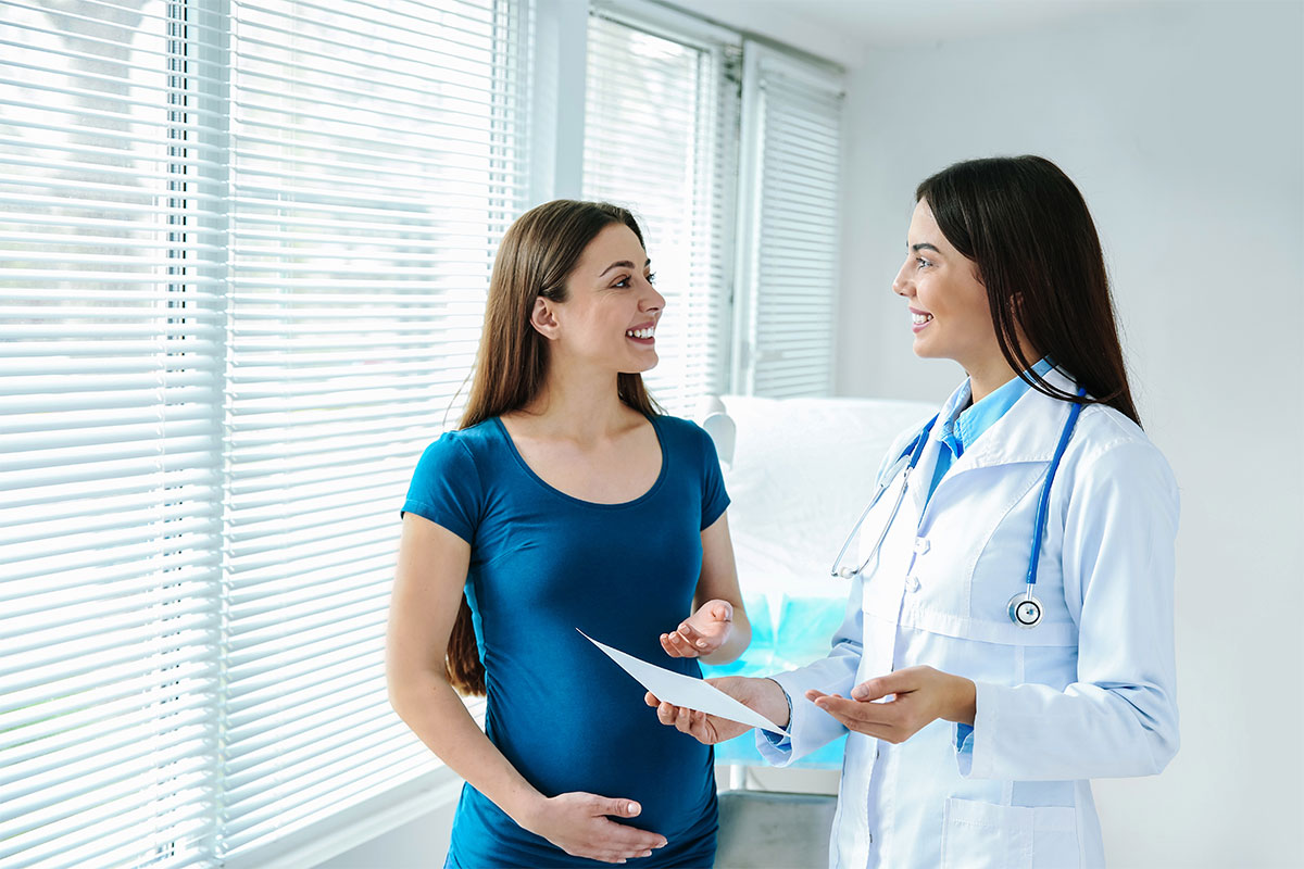 A female gynecologist working with a pregnant woman in a clinic illustrates urinary incontinence during pregnancy.